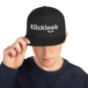 A young man is swearing stylish Klicklook Black Snapback.